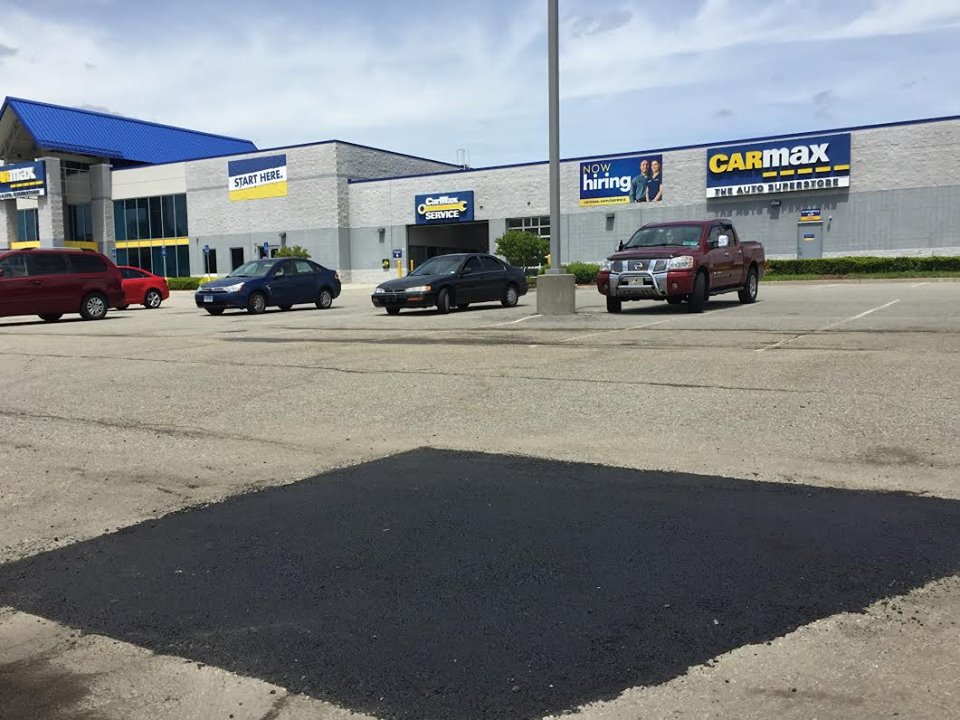 Fresh asphalt patch repair in the CarMax parking lot in East Haven, Connecticut
