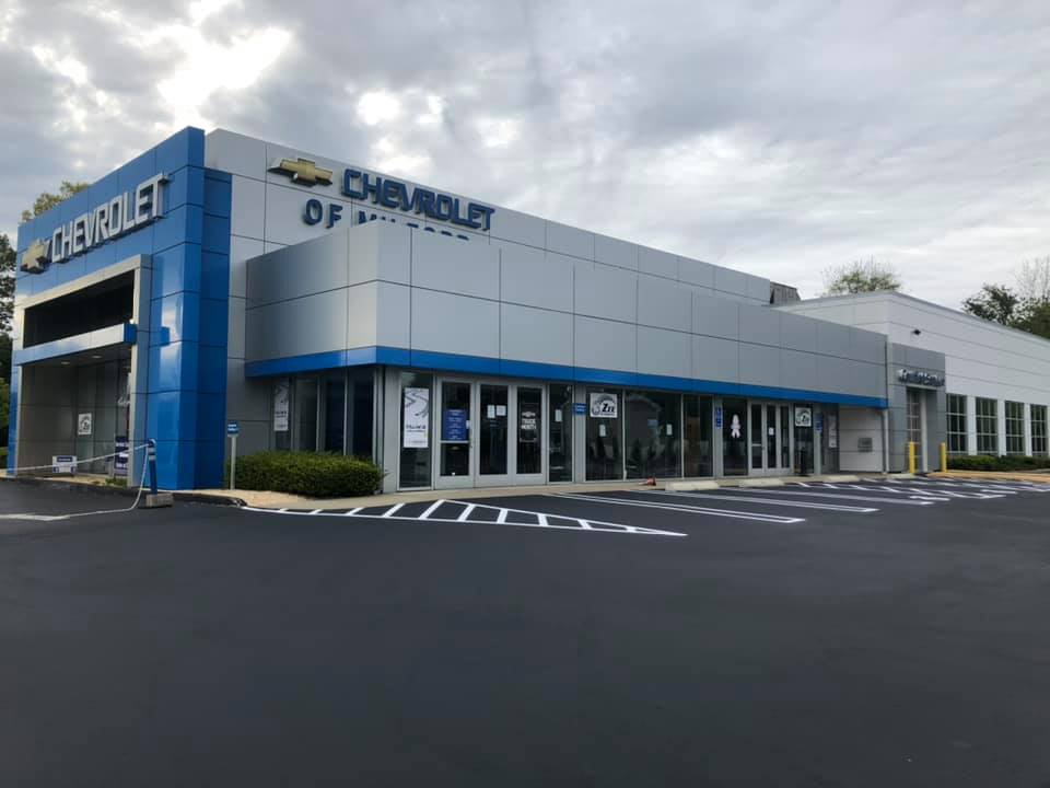 Freshly sealcoated and striped Chevrolet dealership parking lot in Connecticut