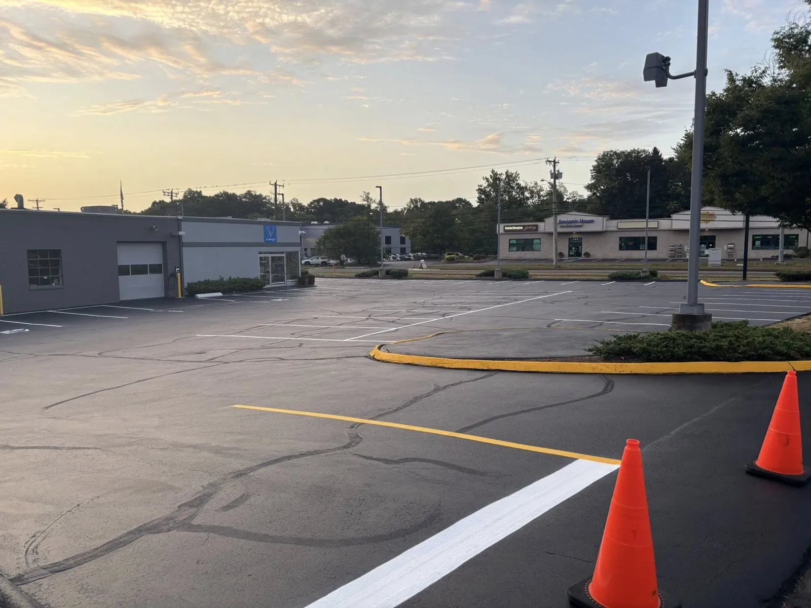 Commercial parking lot with fresh line and curb striping at dusk in Connecticut