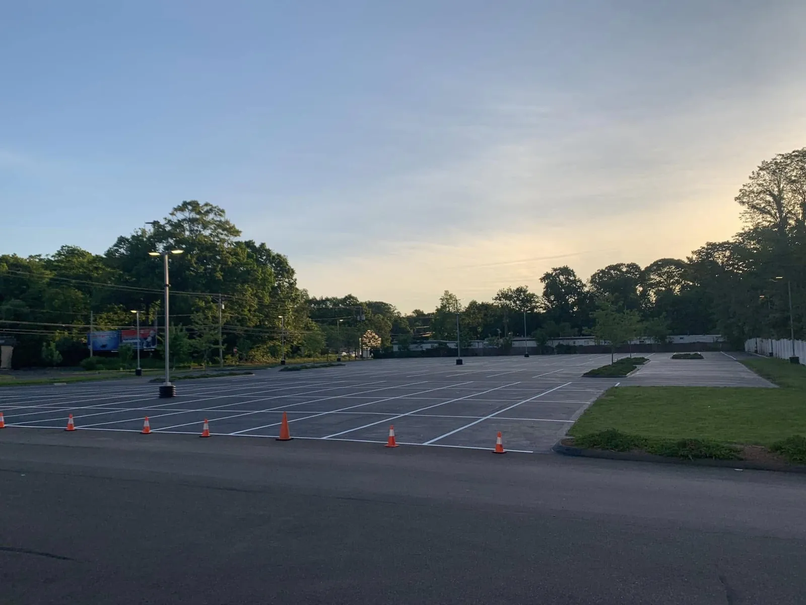Freshly striped commercial parking lot at dusk in Connecticut