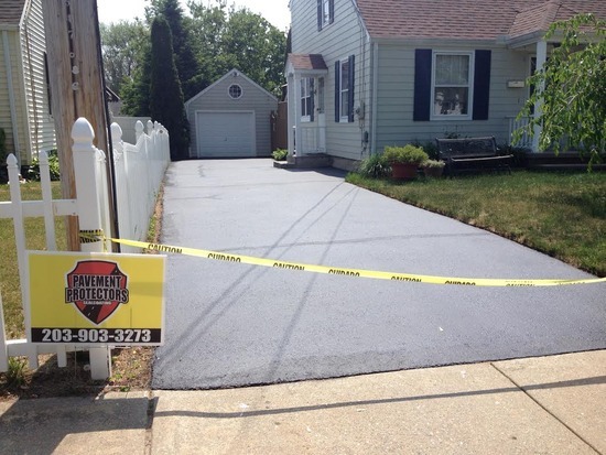 Freshly sealcoated residential driveway in Madison, CT