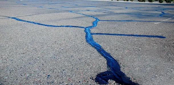 Cracks sealed across a commercial asphalt parking lot