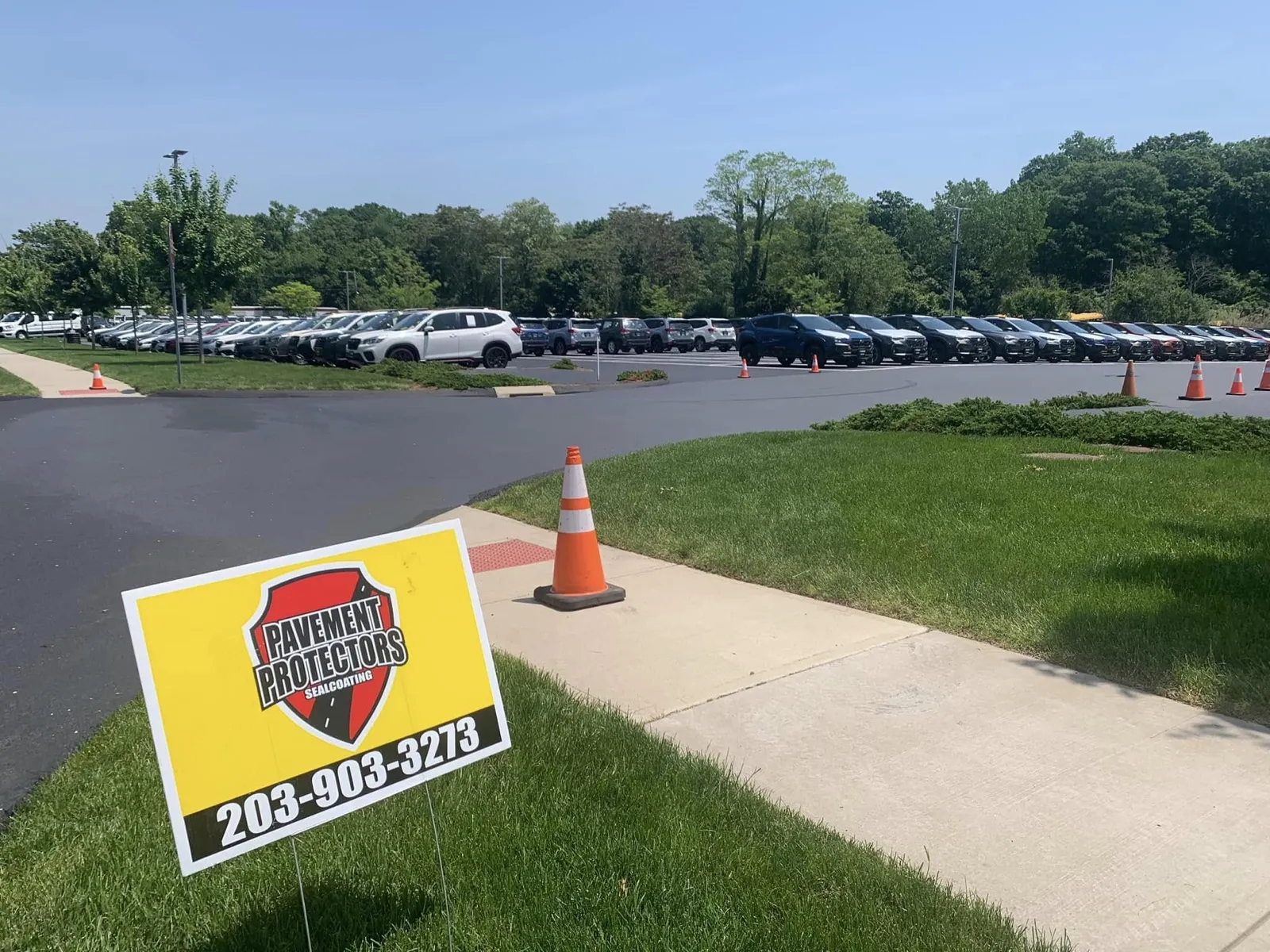 Pavement Protectors yard sign at a commercial parking lot sealcoating job in Connecticut