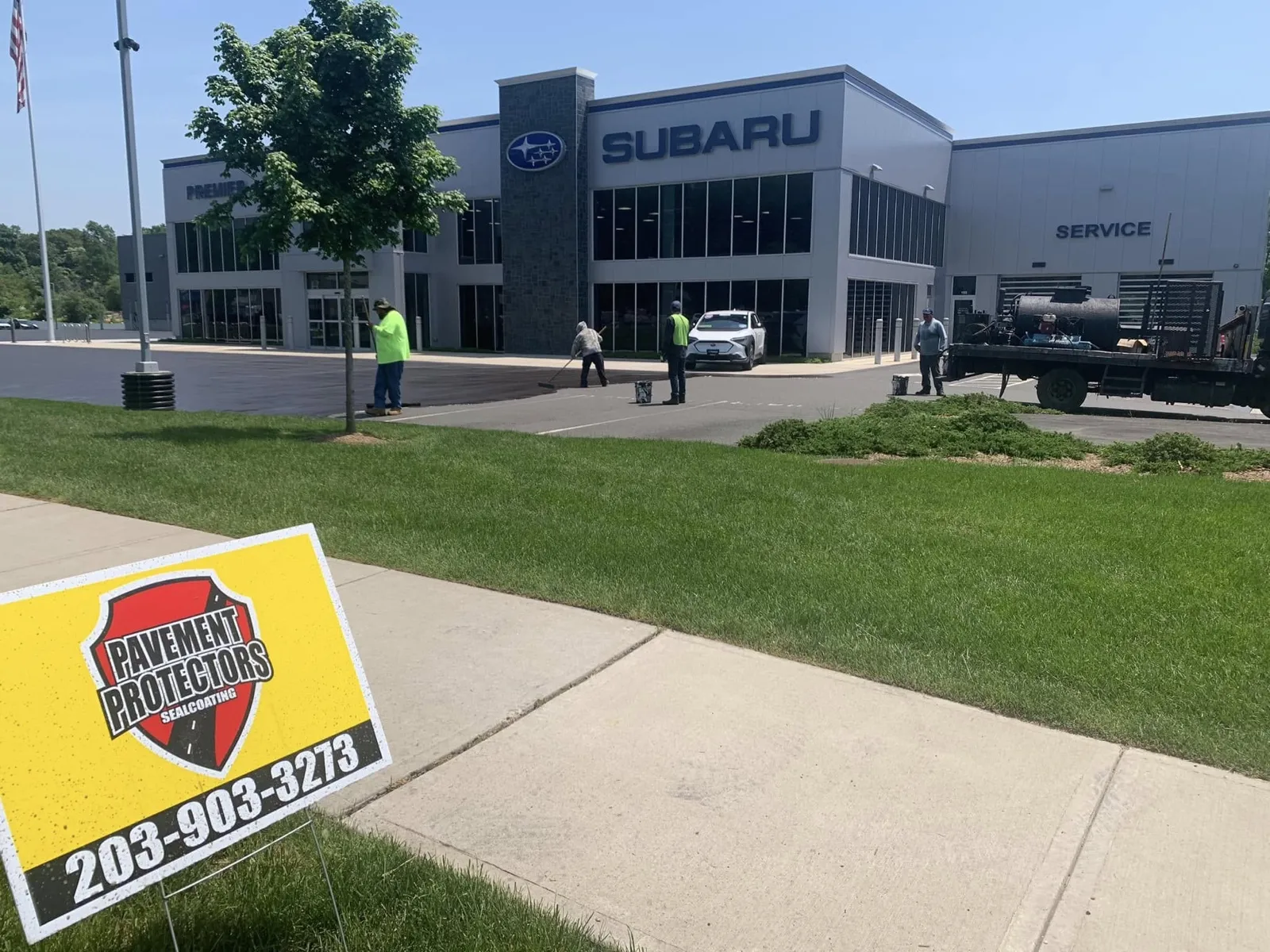 Pavement Protectors crew sealcoating a Subaru dealership in Connecticut